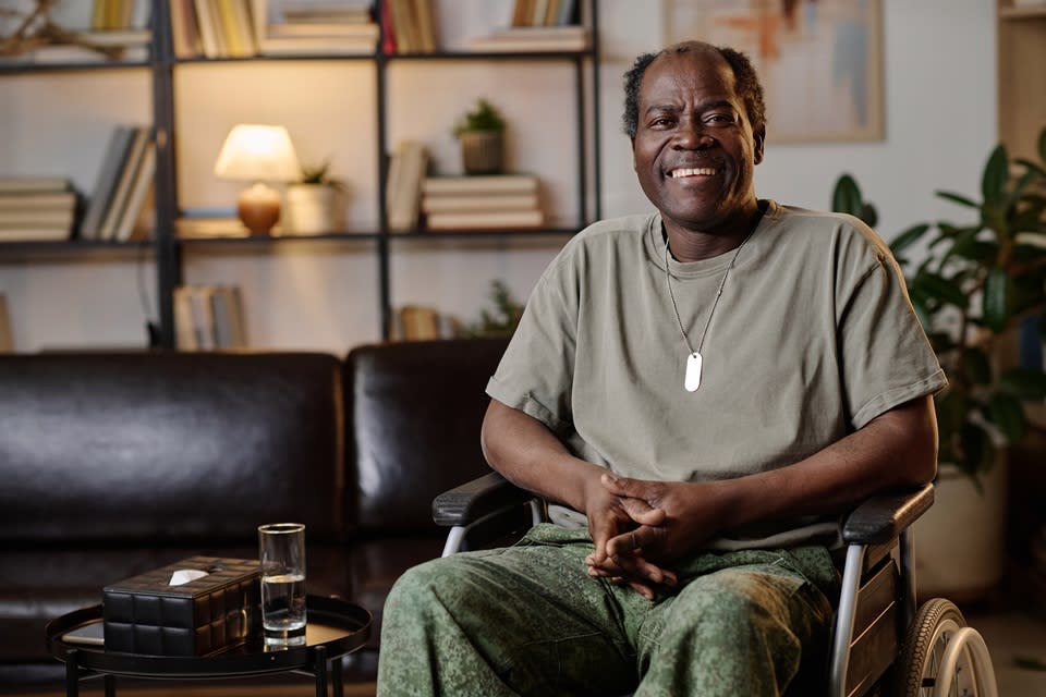 Disabled veteran in wheelchair at home.